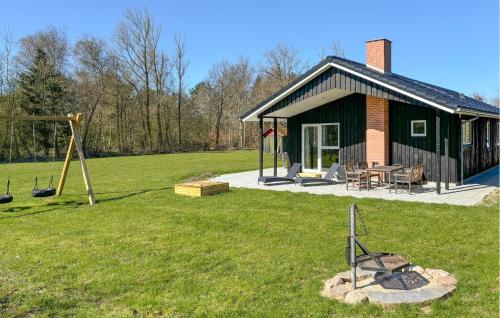a small house with a playground and a swing at Beautiful Home In Spøttrup With Wifi in Spottrup