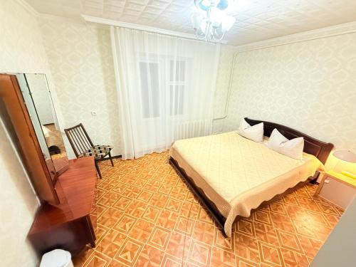 a bedroom with a bed and a mirror in it at Inessa Hostel Room Комната в Хостэле in Chişinău