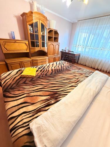 a large bed in a bedroom with a dresser at Inessa Hostel Room Комната в Хостэле in Chişinău
