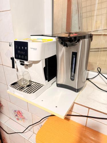 a coffee maker on a shelf on a counter at Inessa Hostel Room Комната в Хостэле in Chişinău