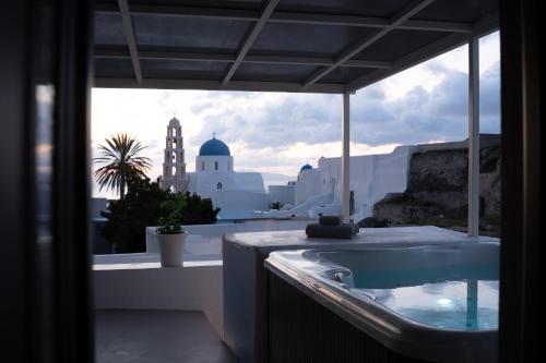 a bathroom with a tub and a view of a building at Marillia's elegance residence in Mesaria