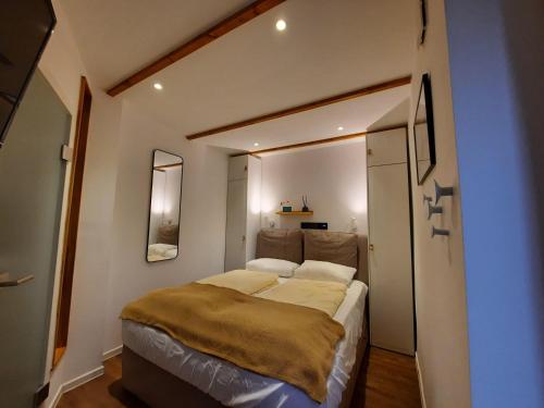 a bedroom with a large bed in a room at Lachmoewe-by-DeJu in Norderney