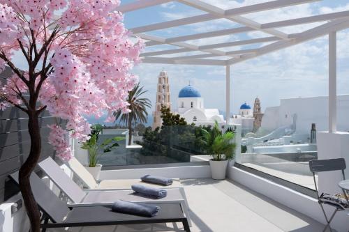 a view of the city from a balcony with a tree at Marillia's elegance residence in Mesaria