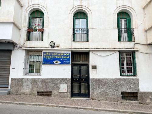 a building with a blue sign on the side of it at Apart Impaca Centro 2 Rooms wifi 5 P excursions in Tetouan