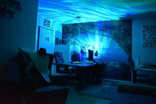 a room with a desk with a blue light at L’orchidée SPA Apartment in Breitenbach