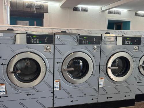 a row of washing machines in a laundry room at B&J HOTEL AND APARTMENTS in Pecos