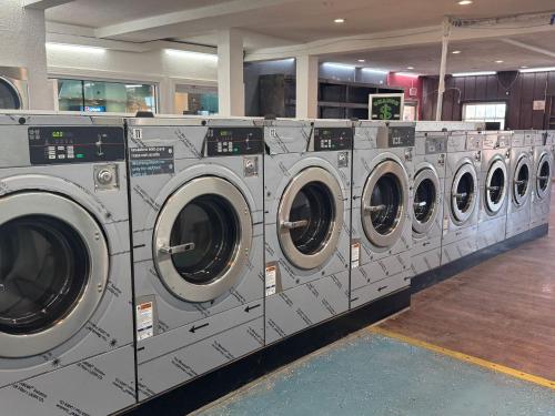 a row of washing machines in a laundry room at B&J HOTEL AND APARTMENTS in Pecos