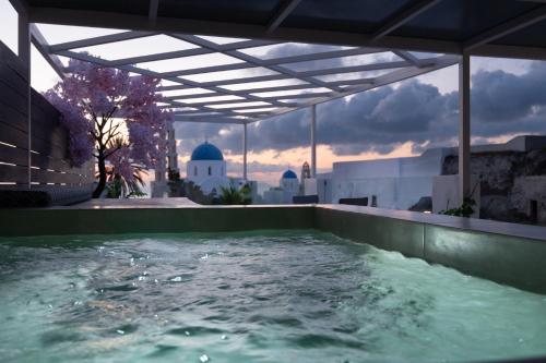 a hot tub on the roof of a building at Marillia's elegance residence in Mesaria