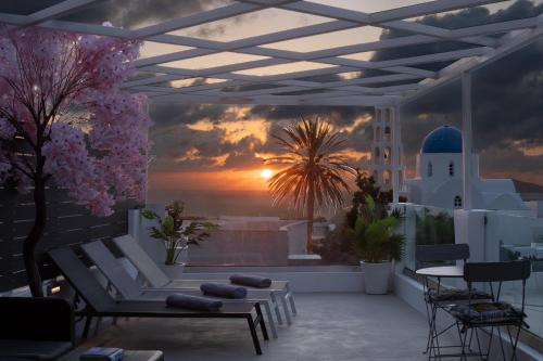 a balcony with a view of a sunset at Marillia's elegance residence in Mesaria