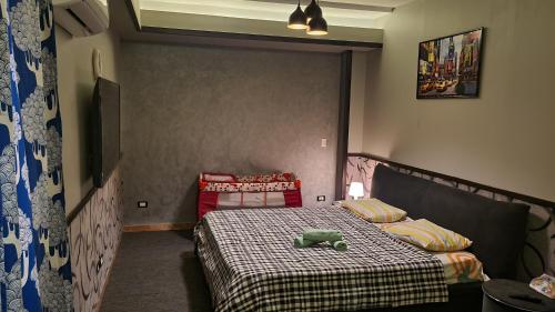 a bedroom with a bed with a teddy bear on it at The Resort Studio - New Cairo in Cairo