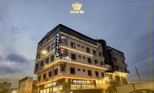 a building with a sign on the side of it at Motel Taj in As Sulaymānīyah
