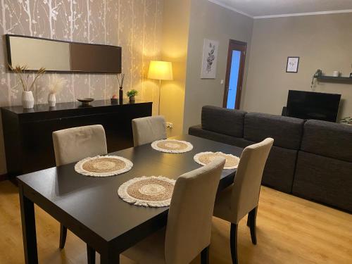 a dining room with a table and a couch at S. Mamede House - Penafiel in Recezinhos