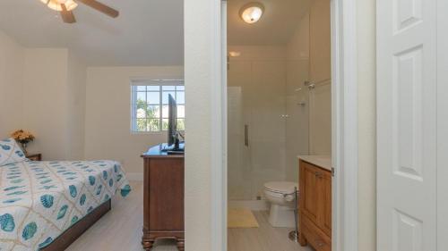 a bedroom with a bed and a shower and a toilet at 408 Mariners Club in Key Largo