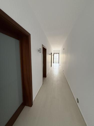 an empty hallway with white walls and a long corridor at Sunny Escape Seaside in Sliema