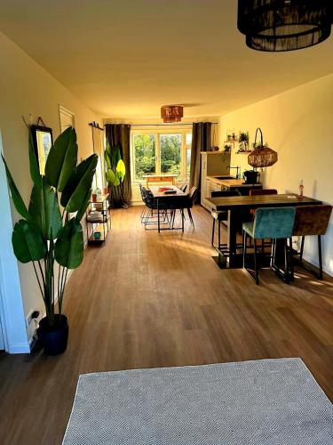 a living room with a table and a dining room at Sonsbeek city apartment "De Merel" in Arnhem