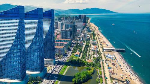 an aerial view of a beach with buildings and the ocean at ORBI City LUXE HOTEL in Batumi