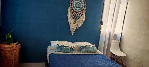 a blue bedroom with a bed with pillows on it at Casa Campestre en Pueblo Mágico in Santa Bárbara