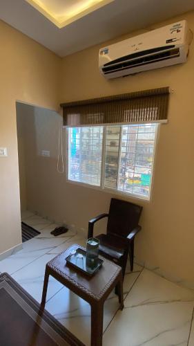 a living room with a chair and a table at Jhankar home stay in Ujjain