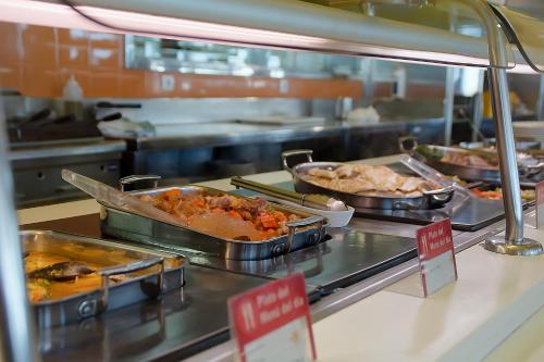 a buffet line with several trays of food on display at Hotel AS Torrent in Torrent