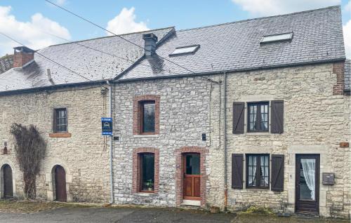 an old brick building with windows and a roof at 2 Bedroom Pet Friendly Home In Treignes in Treignes
