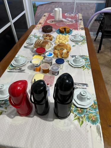 a table with a table cloth with food on it at Recanto Luna in Foz do Iguaçu
