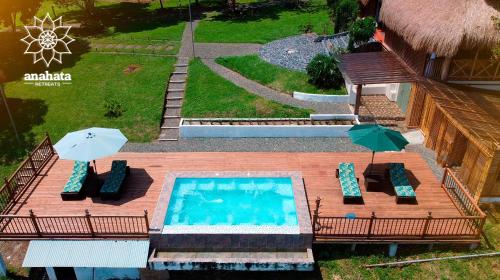an aerial view of a swimming pool with chairs and umbrellas at Anahari Centro Wellness in Quimbaya