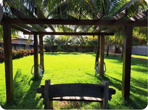 a park with a bench and a pergola at Casa Aconchegante e Econômica in Sinop