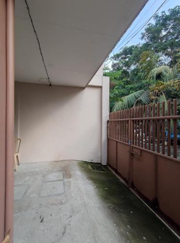 an empty room with a balcony with a fence at Holiday House in Ormoc