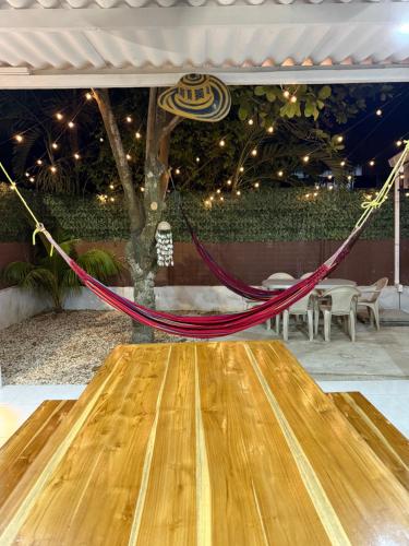 a wooden table with a hammock on it at Cabaña OtraParte in Rincón