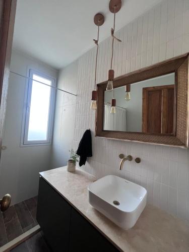 a bathroom with a sink and a mirror at Casa Ancona casa quinta in Joaquín Gorina