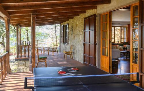 a room with a ping pong table on a porch at 4 Bedroom Nice Home In Pergola in Pergola
