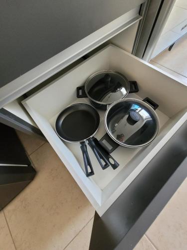 a kitchen counter with two pans and utensils on it at Casa Privada El Marqués Qro in Querétaro