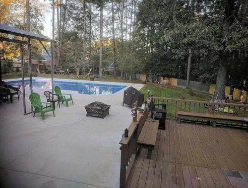 a patio with tables and chairs next to a pool at Evans-5bd, 4bh, AC, WiFi, Pool in Evans