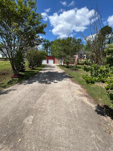 an empty road with trees and a red garage at Evans-5bd, 4bh, AC, WiFi, Pool in Evans