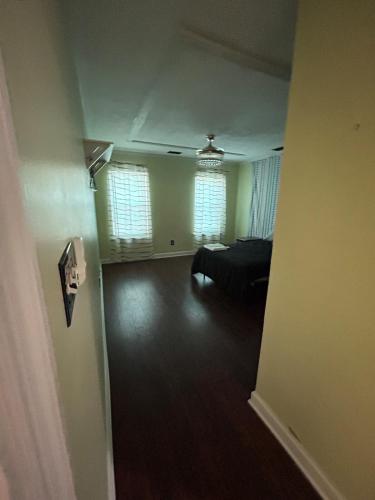 a living room with a couch and two windows at Evans-5bd, 4bh, AC, WiFi, Pool in Evans