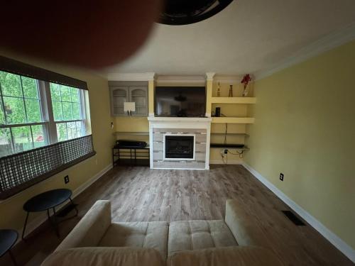 a living room with a couch and a fireplace at Evans-5bd, 4bh, AC, WiFi, Pool in Evans