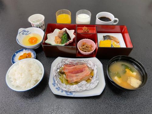 a table with a plate of food and bowls of food at Dochu Land Shin Onsen in Awa