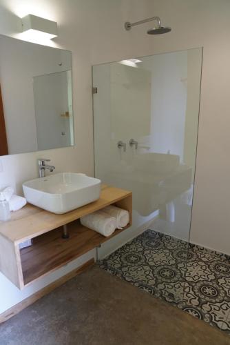a bathroom with a sink and a mirror at Hotel con Corazon Monteverde in Monteverde Costa Rica
