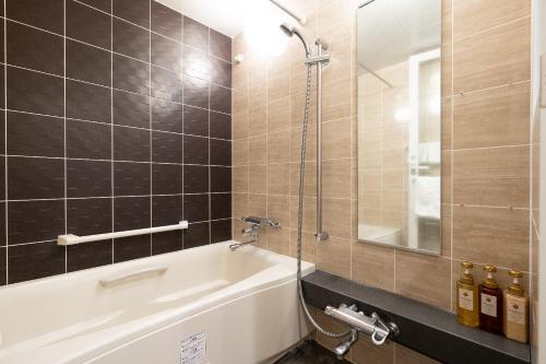 a bathroom with a bath tub and a shower at Tokyu Stay Aoyama in Tokyo