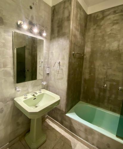 a bathroom with a sink and a bath tub at Apart juncal in Buenos Aires