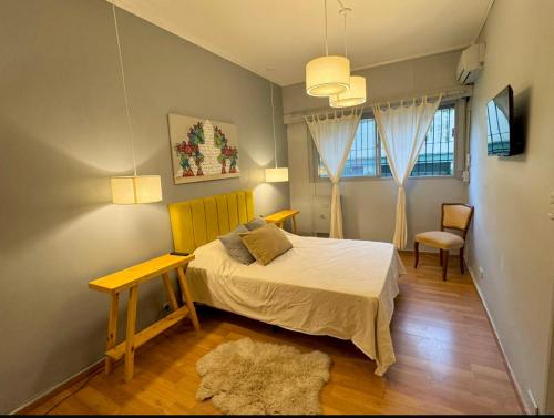 a bedroom with a bed and a table and a chair at Apart juncal in Buenos Aires