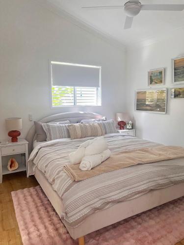a bedroom with a large bed with two pillows on it at Frankie's on Frank in Scarborough