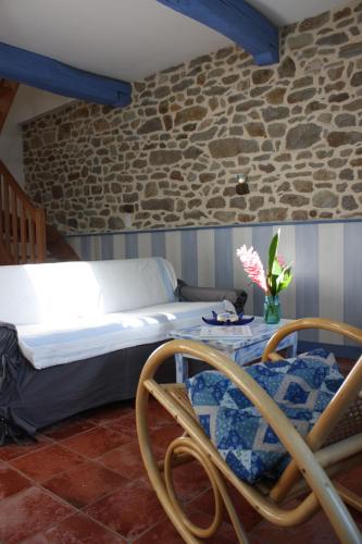 a bedroom with a bed with a table and chairs at Les Keriaden's in Pleudihen