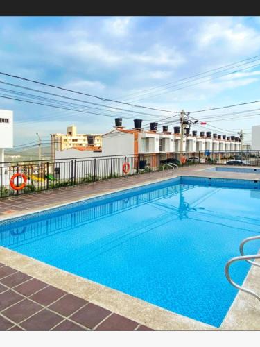 a swimming pool on the side of a building at Blue House in Los Patios