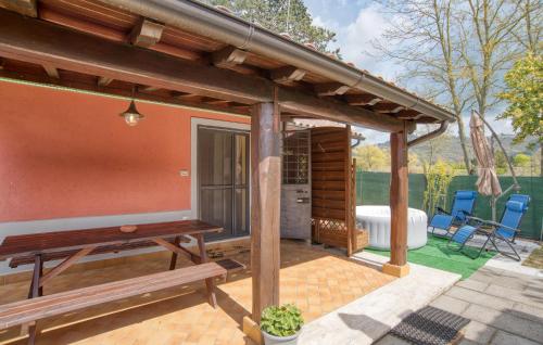 a wooden pergola with a bench on a patio at Cozy Home In Montefiascone in Montefiascone
