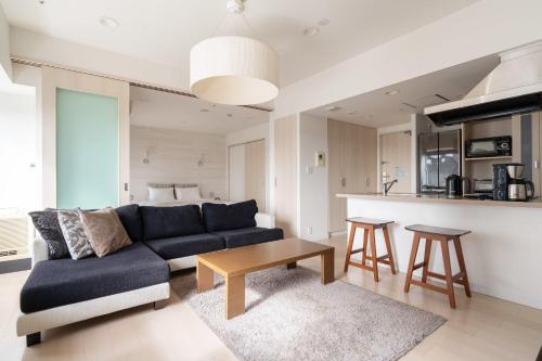 a living room with a couch and a table at Tokyu Stay Aoyama in Tokyo