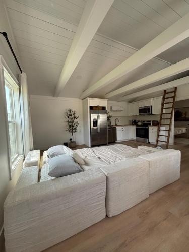 a large white bed in a room with a ladder at Luxury BoilingSprings Getaway in Boiling Springs