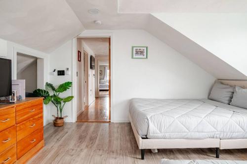 a living room with a bed and a tv at NEW! Family-Friendly Getaway -1 Mi to Dtwn Salem w Roof Deck & Tiki Bar in Salem