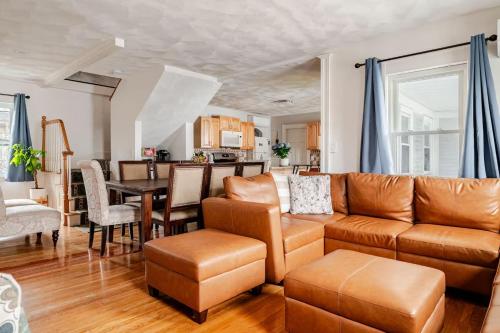 a living room with a couch and a table at NEW! Family-Friendly Getaway -1 Mi to Dtwn Salem w Roof Deck & Tiki Bar in Salem