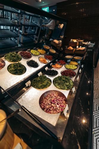 a buffet with many different types of pizzas on display at Pullman Singapore Orchard in Singapore